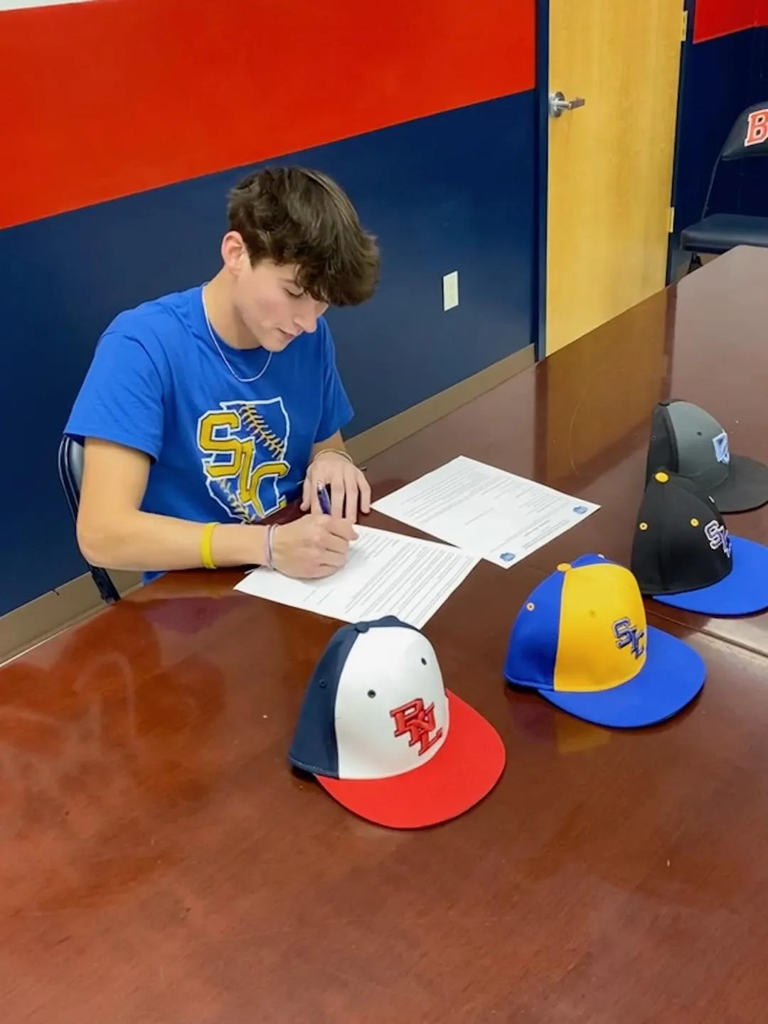 BNL outfielder Grant Dalton signs his scholarship deal to play at Southeastern Illinois College following his senior year.